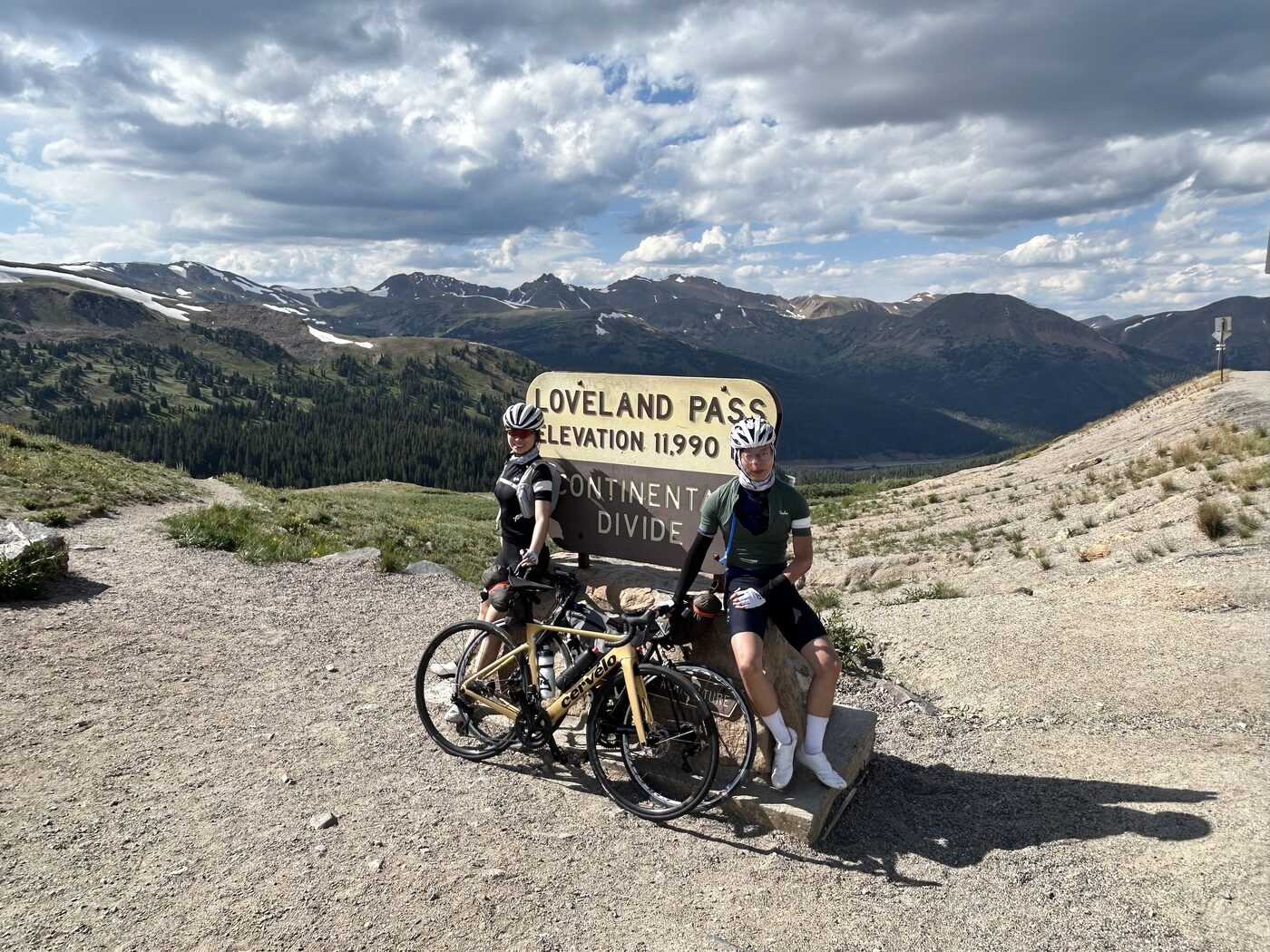 Anna and her partner with loaded bicycles at Loveland Pass, Colorado